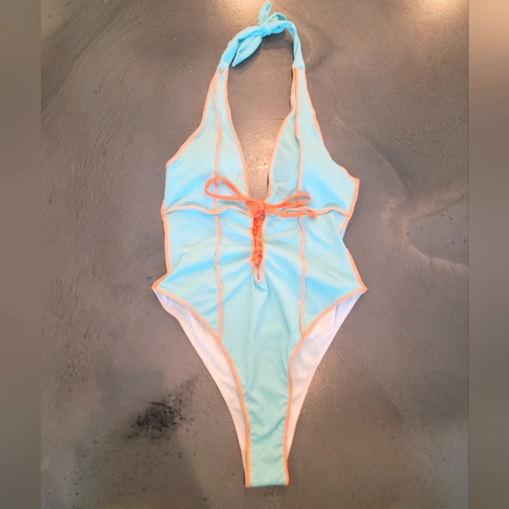 Light blue one-piece with Orange stitching